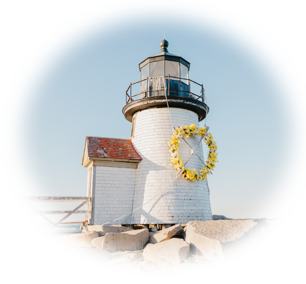Brant Point lighthouse with a wreath of daffodils strapped to the side