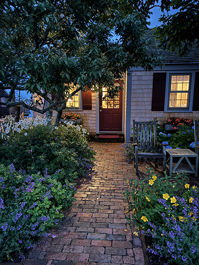 evening walkway through a beautiful Nantucket garden to a cottage