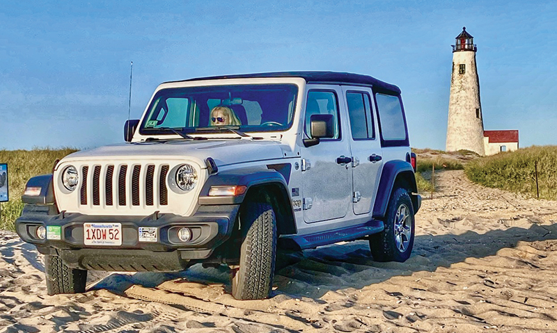 jeep on the beach in front of great point lighthouse on Nantucket